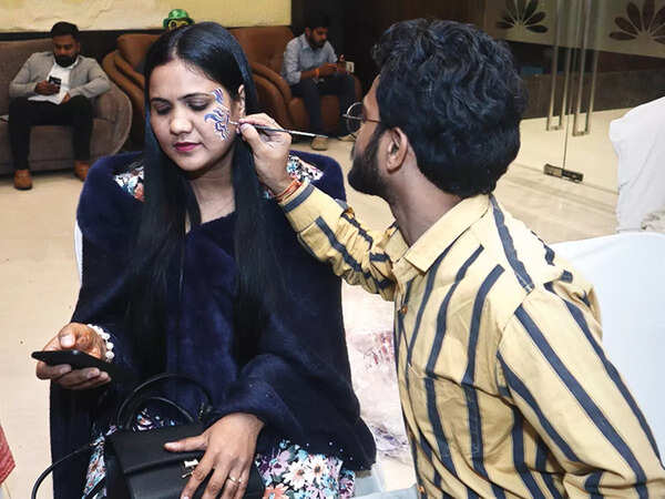 Priya getting a tattoo made at the party