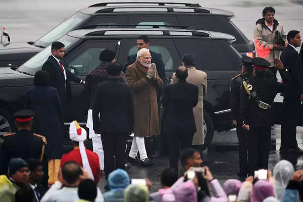 India's Prime Minister Narendra Modi (C) gestures upon his arrival to attend the.