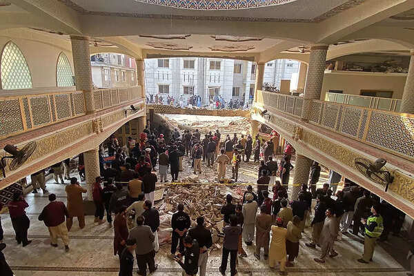 Security officials inspect the site of a mosque blast inside the police headquarters in Peshawar on January 30, 2023. At least 17 people were killed in a mosque blast at a police headquarters in Pakistan, a (1).