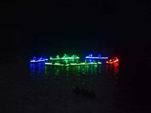 Illuminated boat floating in the Mula river