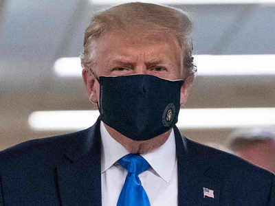 Trump finally dons mask as US sets new record