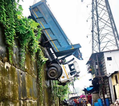 Dumper nose-dives into slum below