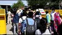 Passengers line up outside NDLS to board trains for home 