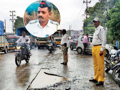 Traffic cop run over while avoiding pothole