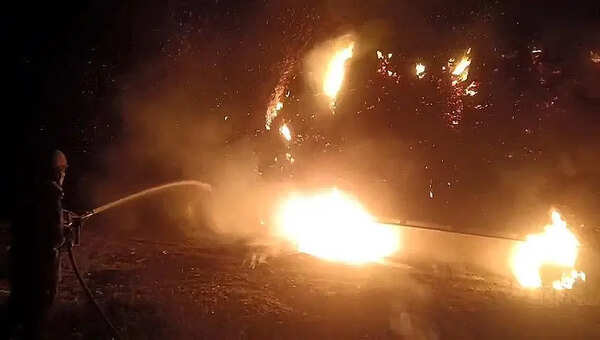 Hay touches wire, flames from tractor leap to house & shop