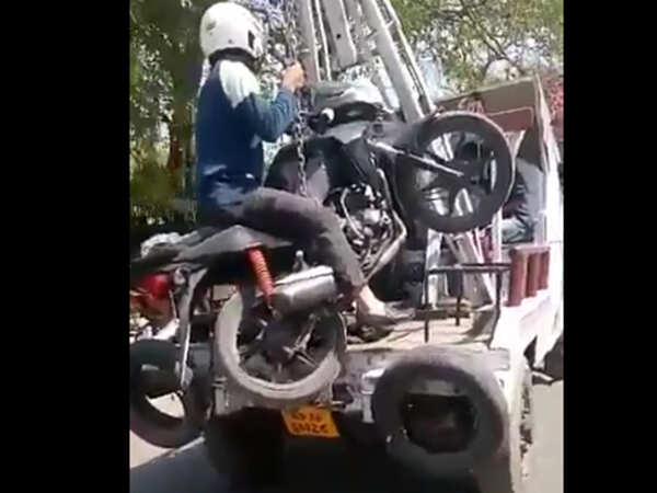 Rider towed away along with bike