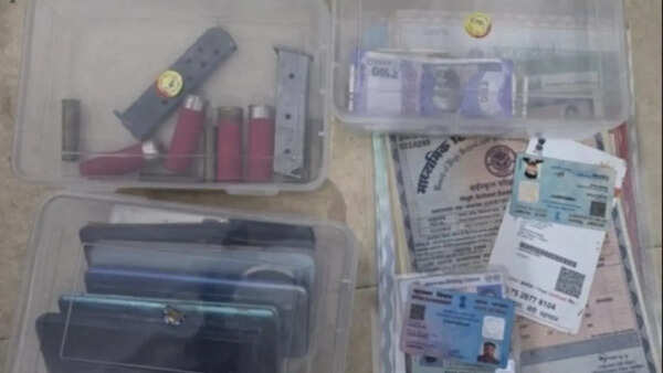 Pistol, cartridges, fake currency and multiple IDs seized from Aligarh Muslim University hostel room; suspect on run