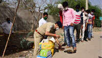 Rajasthan: Policemen provide food, slippers to migrants returning home on foot 