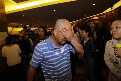 Search for missing Malaysian plane suspended, families cry foul
