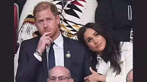 Meghan leans her head against his shoulder