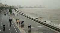 People get drenched by a large wave during high tide in Mumbai 