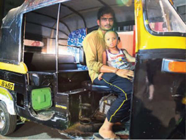 Paralysed wife at home, auto driver plies around with 2-yr-old son in lap