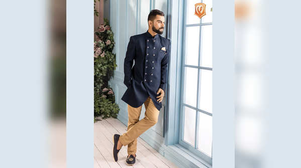 1. Mid night blue double-breated indo-western with an asymmetric cut and antique detailed buttons