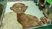 Artist attempts world record by painting Mahatma Gandhi’s massive portrait using coffee powder 