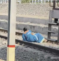 Woman braces rly tracks as train starts moving; escapes unhurt