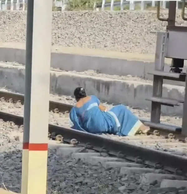 Woman braces rly tracks as train starts moving; escapes unhurt