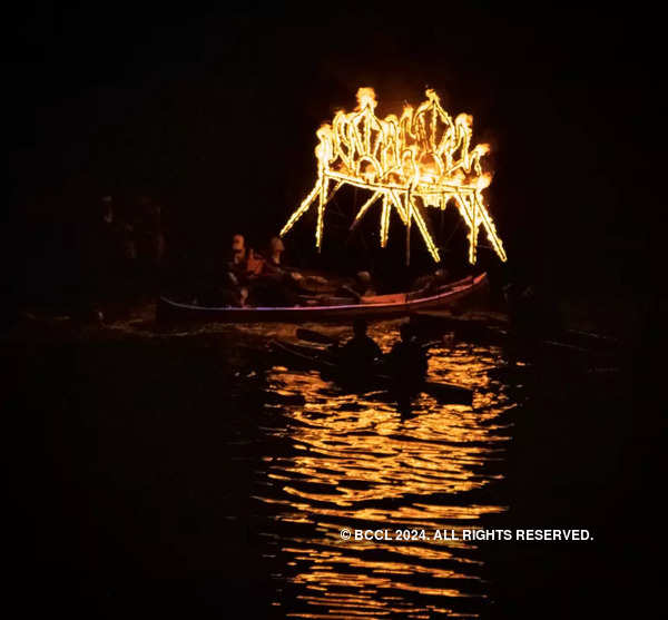 Boats and torches light up the river at COEP's Regatta