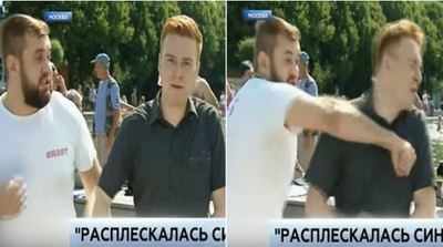 Russia: Drunk man slaps news reporter on live TV