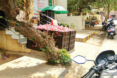 Department store blocks pavement with crates of  onions, in Nandini Layout