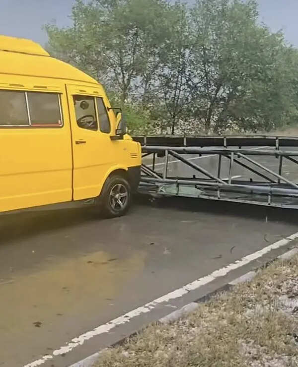 Storm-toppled sign misses van in Moga