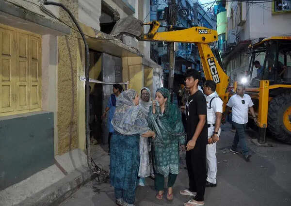 Residents rush out with essentials from house