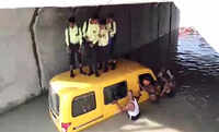 UP: Locals rescue children after school van gets stuck in waterlogged underpass in Kushinagar 