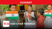 PM Modi’s mother distributes National Flags to children 