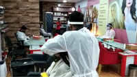 Beauty parlour staff at Kolkata shopping mall wears PPE kits to serve customers 