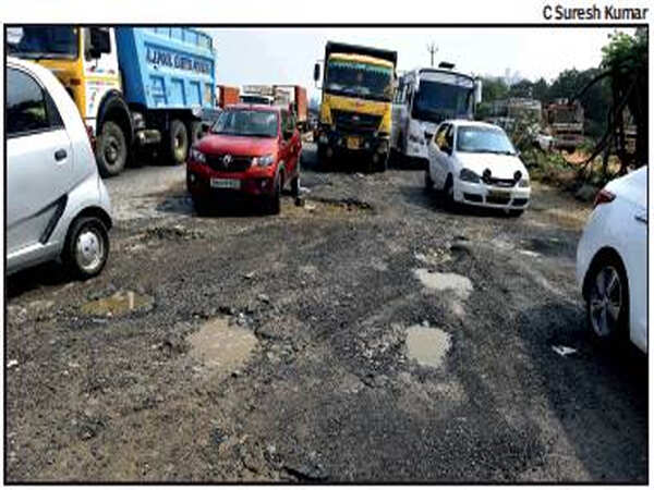 Irked by holdup, truckers repair battered highway