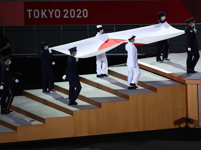 Japan flag is carried during the opening ceremony. (Reuters Photo)