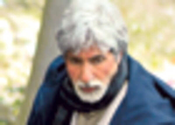Amitabh walks down sleet street 