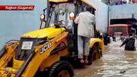Watch: JCB machine pulls out bus stuck under waterlogged bridge in Gujarat’s Rajkot 