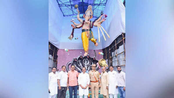Ganesh idols being secured against heavy rain right after arrival