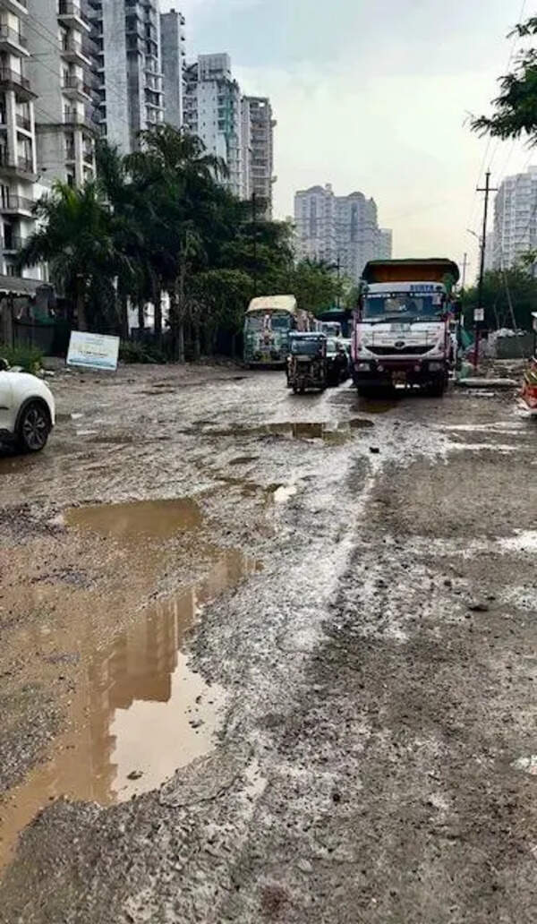 Road leading to school, condos littered with craters, flood-prone