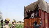 Uttar Pradesh: Cops caught loading migrants into truck, covering vehicle with tarpaulin 