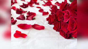 Why is the Indian wedding bed decorated with red roses?