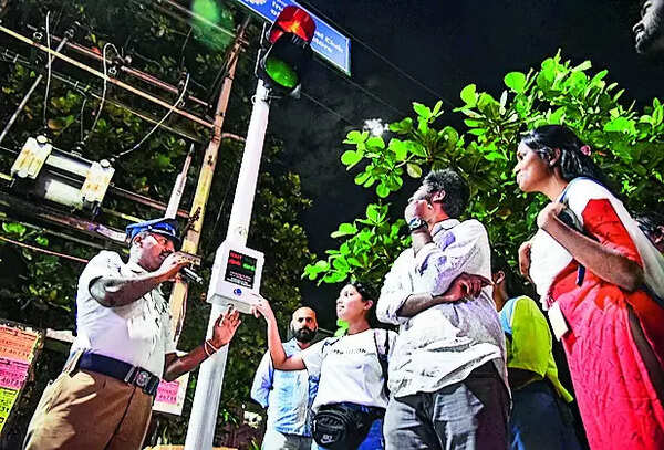 Police allow pedestrains to man signal to cross road