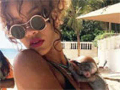 Rihanna flaunts her figure with new friend