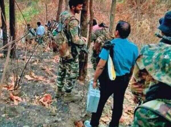 Odisha: Polling personnel trek 12km in forest route to reach Tumudibandha
