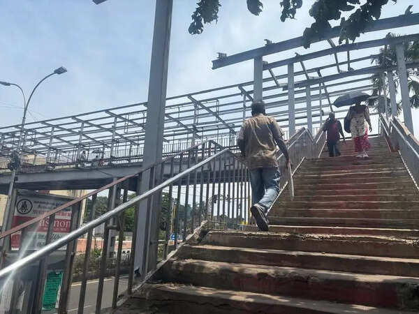 No roof in sight at Fort station’s foot overbridge; commuters brave elements