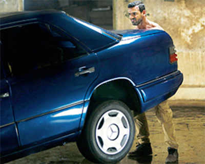 From bike to car, John Abraham muscles it