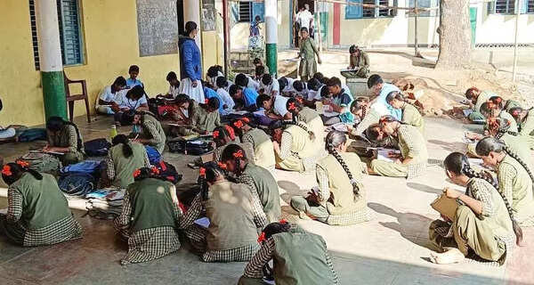 Insufficient classrooms force students to sit on floor in a village high school near Mariammanahalli
