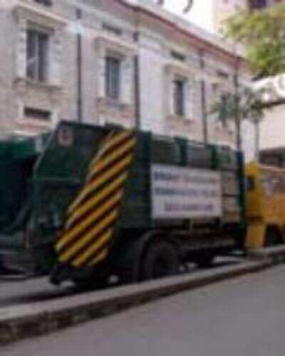 Garbage-collecting trucks gather dust