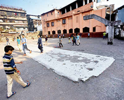 Here, kids play cricket on a concrete pitch