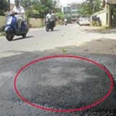 Manhole is mistaken for pothole and asphalted!