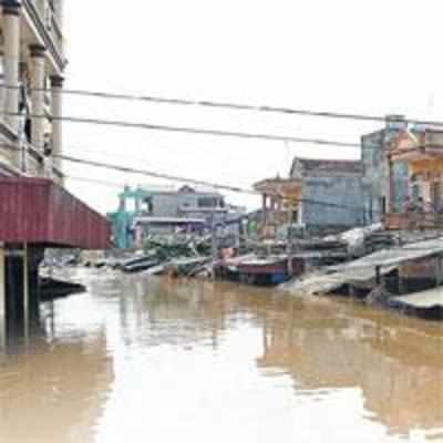 Floods sink Vietnam, typhoon hits China