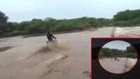 On cam: Lucky escape for biker swept away in flooded river 
