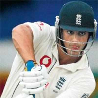 Cook and rain keep England afloat