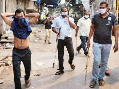 Police personnel hit man, force him to use shirt as mask