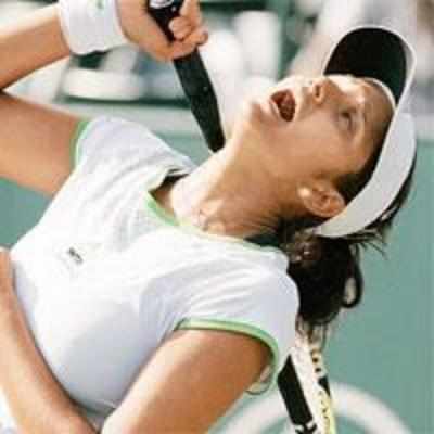 Sania out of singles, advances in doubles